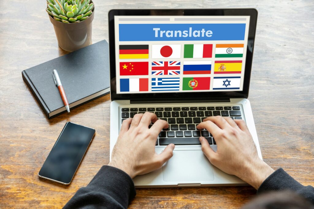 Man working on a laptop with the word translate on the computer screen